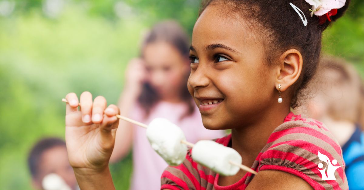 From Sketch Notes To Marshmallows A Relationship Look At Self-Reg. Image is of a young girl with a marshmallow on a stick.