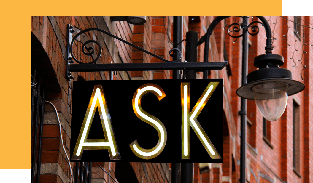 Shop sign saying ASK with a lamp