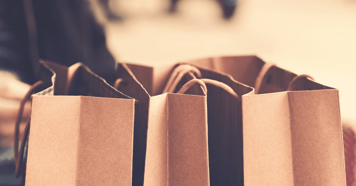 Photograph of 3 brown paper shopping bags with twine handles