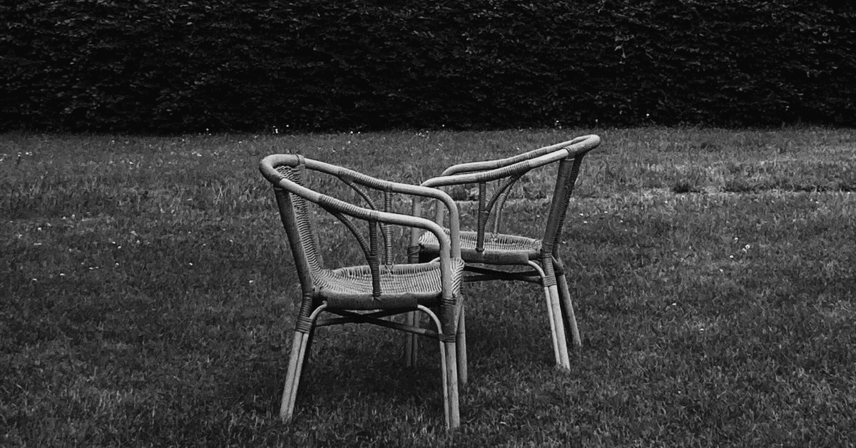 Two garden chairs facing each other arm to arm on one side