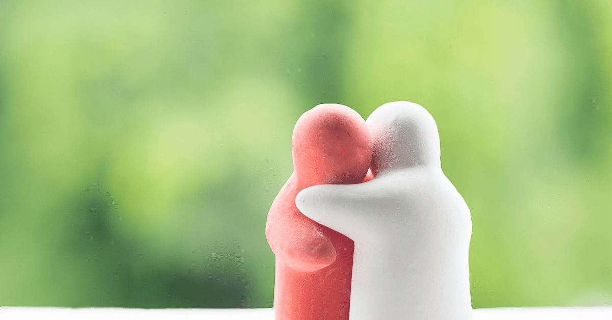 Image of two clay models of people hugging