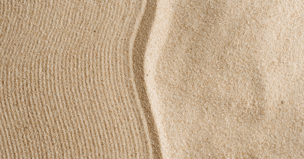 a line in the sand dividing natural sand and raked sand