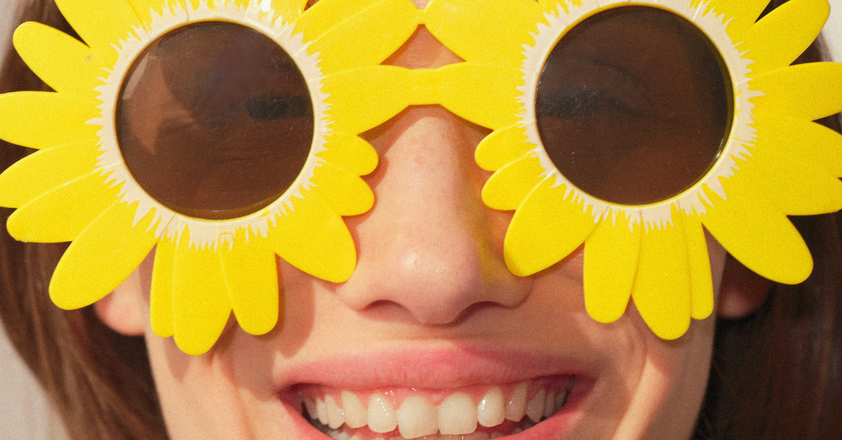 person smiling wearing flower sunglasses